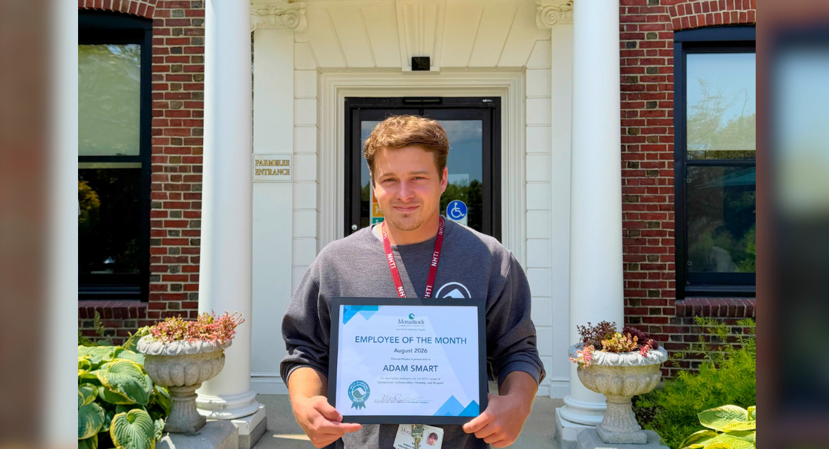 adam smart holding his certificate